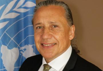 Official photo shows Gustavo González in front of the UN flag.
