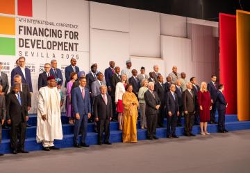 A group of people including the DSG stand in front of a banner