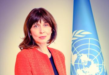 A high-level female UN official poses for a photo.