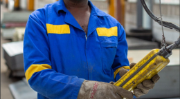 Cover shows the title, "Immediate Socio-Economic Response to COVID-19 in Zimbabwe," over an image of a machine operator wearing a protective face mask as he works.