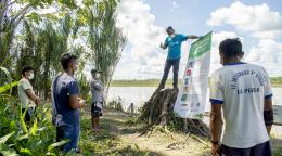 Fredy Vargas, UNICEF Community Engagement Consultant, discusses safe hygiene practices with indigenous community leaders in the Peruvian Amazon.