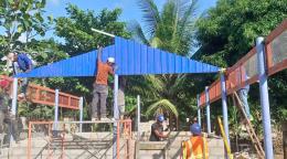 Construction workers are shown building the foundation of a new facility. 