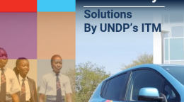 An electric vehicle with three girl students walking next to it (Namibia).