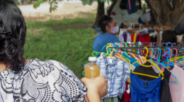 Woman standing backwards to camera, selling fresh juice.