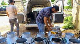 Workers check fresh milk in a Lebanese farm in the Beqaa Valley.