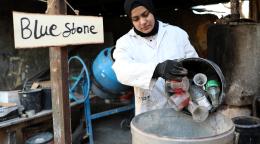 Rawan-empties-used-glass-into-a-barrel