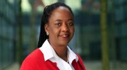 A woman in a red suit and white shirt