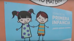 A cartoon depicted on a brick-reddish wall, showing two stick figures clasping hands