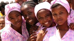 A picture of four girls in pink dresses