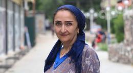 A Tajiki woman poses for a photo.