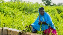 A Malian woman accesses a water spout.