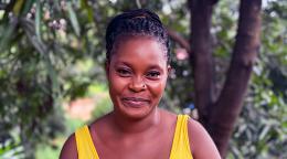 A woman in Sierra Leone smiles for a photo.