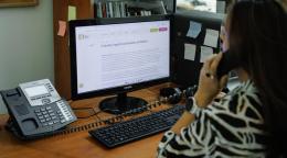 A woman in Moldova looks at a computer screen.
