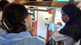 A young Djiboutian solar energy entrepreneur presents her company’s products to a participants during a national forum.