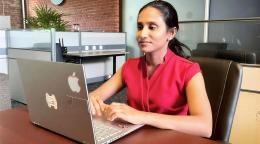 A woman in Sri Lanka uses her laptop.