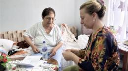 A woman in Albania takes care of an elderly woman.