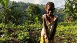 A young girl in a field in Comoros.