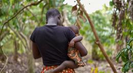 A woman holds her child.