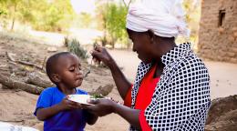 A mother in Kenya feeds her son.