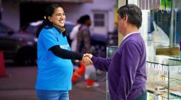 A female UN volunteer in Peru shakes hands with a local.