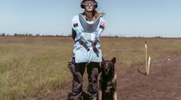 A mine detection dog handler, with her dog.
