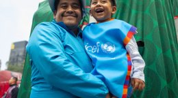 A man in Mexico holds his son.