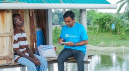 A UN Volunteer speaks to a local community member in Bangladesh.