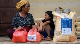 A woman and a child receive aid following floods in Nepal.