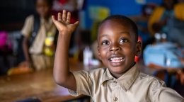 A young student in Jamaica raises his hand.