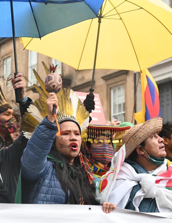 A group of activists with umbrellas, signs, posters