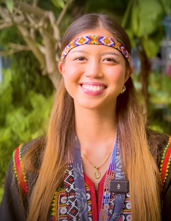A woman in traditional clothing smiling at the camera