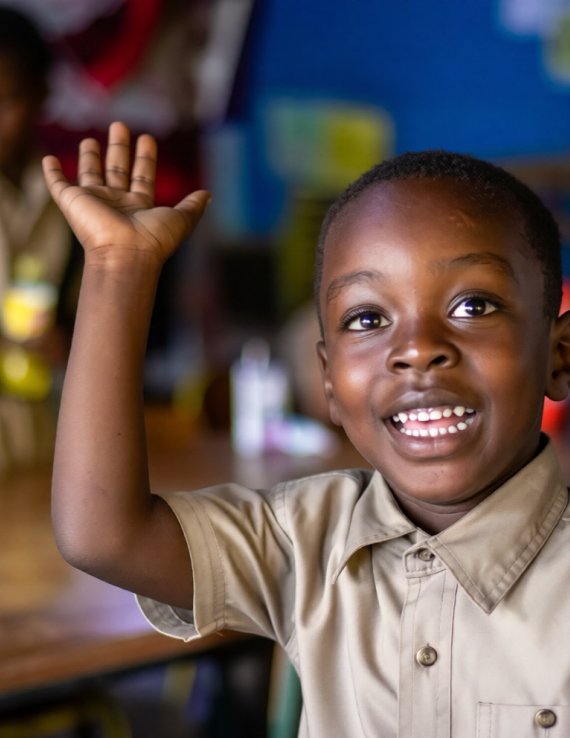 A young student in Jamaica raises his hand.