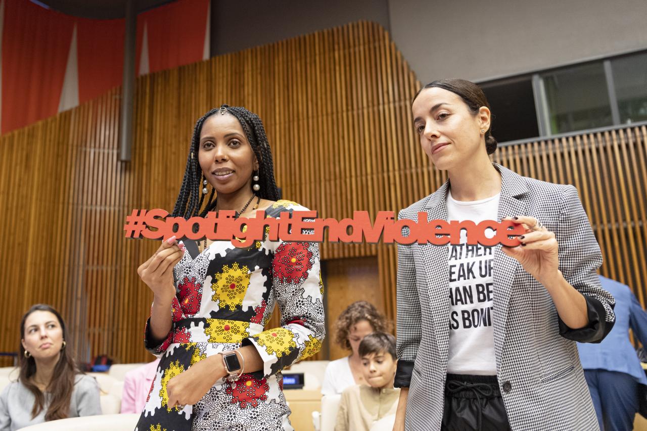 Participants at the EU-UN event on Eliminating Violence against women and girls show a sign that reads #SpotlightEndViolence.