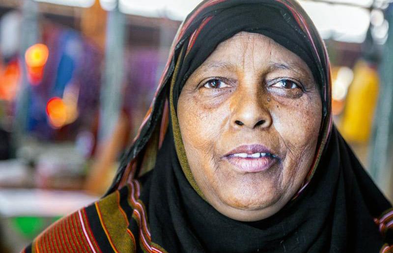 Shows a close-up of Khadra looking directly at the camera.