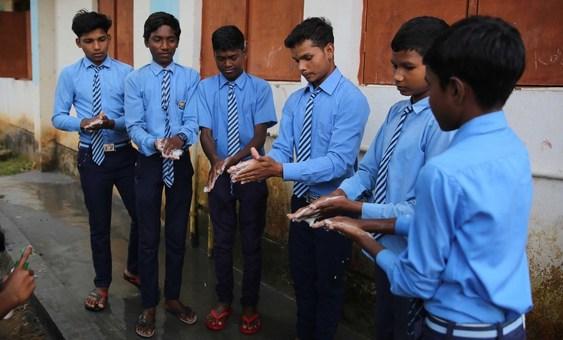 Pupils at a school in Chhattisgarh in northeastern India practice safe-hand washing techniques.
