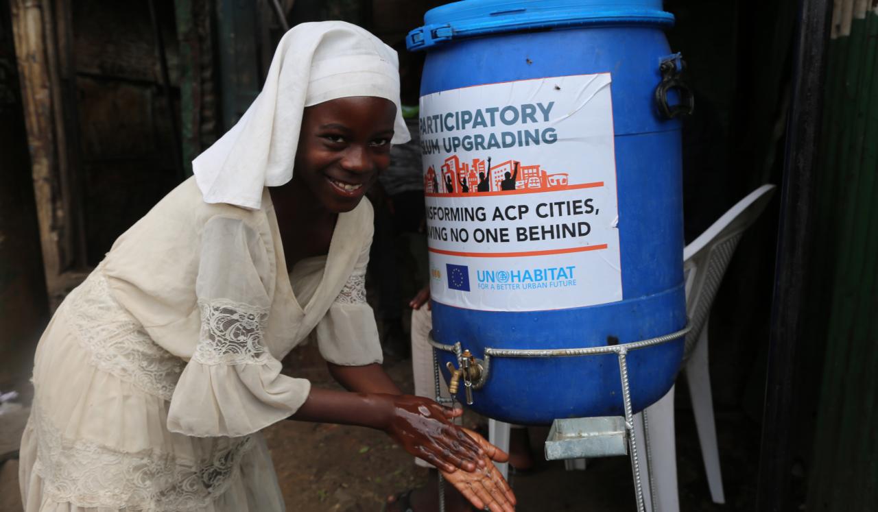 A woman at one of the hand washing facilities installed by UN-Habitat in Mathare slum in Nairobi, Kenya.