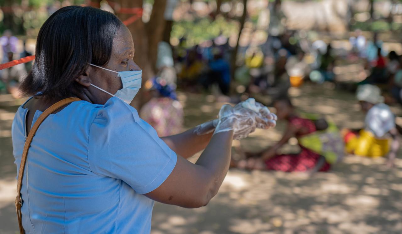 Caroline Allan, a district health officer, demonstrates proper hand-washing technique. 