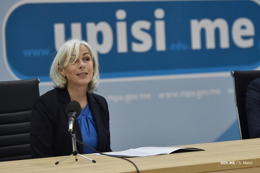 Fiona McCluney, Resident Coordinator of the UN System in Montenegro, is shown speaking into the microphone during a panel discussion.