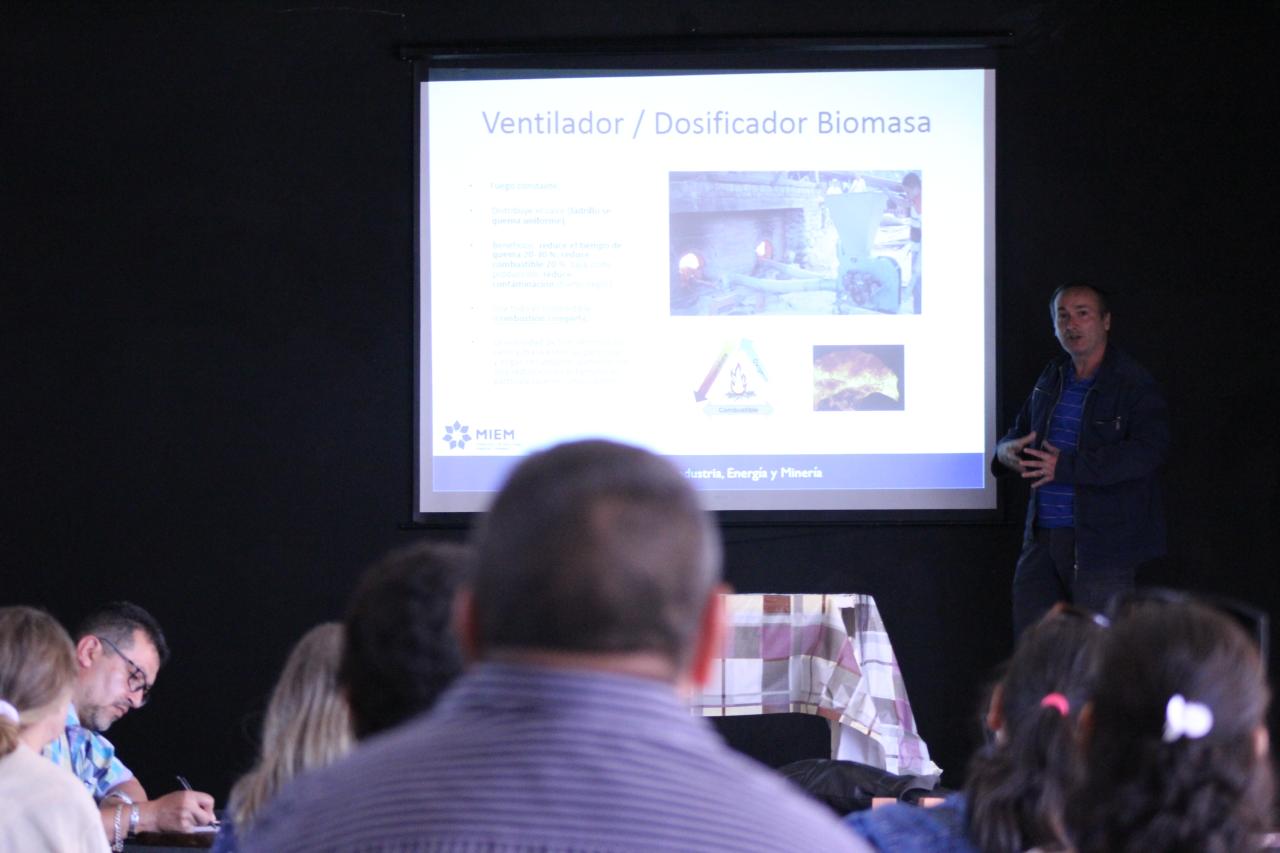 Photo shows a PAGE representative presenting to artisanal brickmakers on how to make better and cleaner bricks more efficiently.