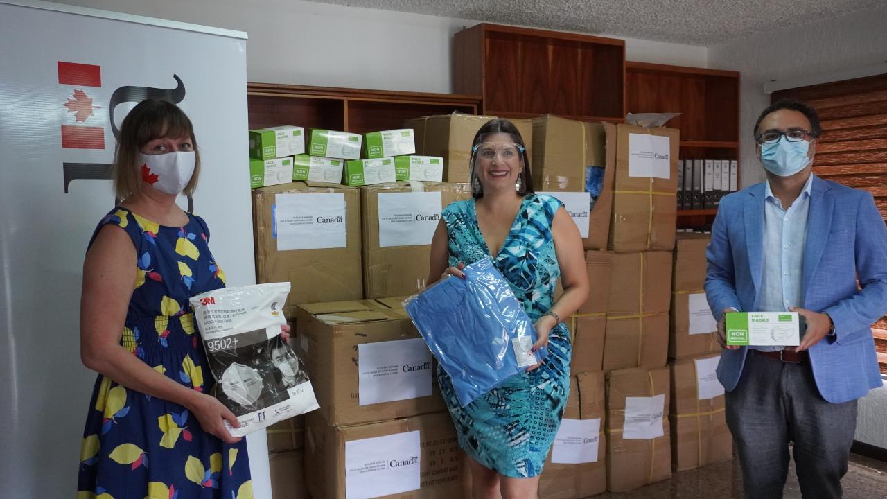 UN personnel hold samples of the essential supplies donated to the country.