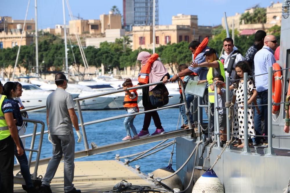 Refugees and migrants disembark from a rescue ship in the Central Mediterranean disembark in Malta.