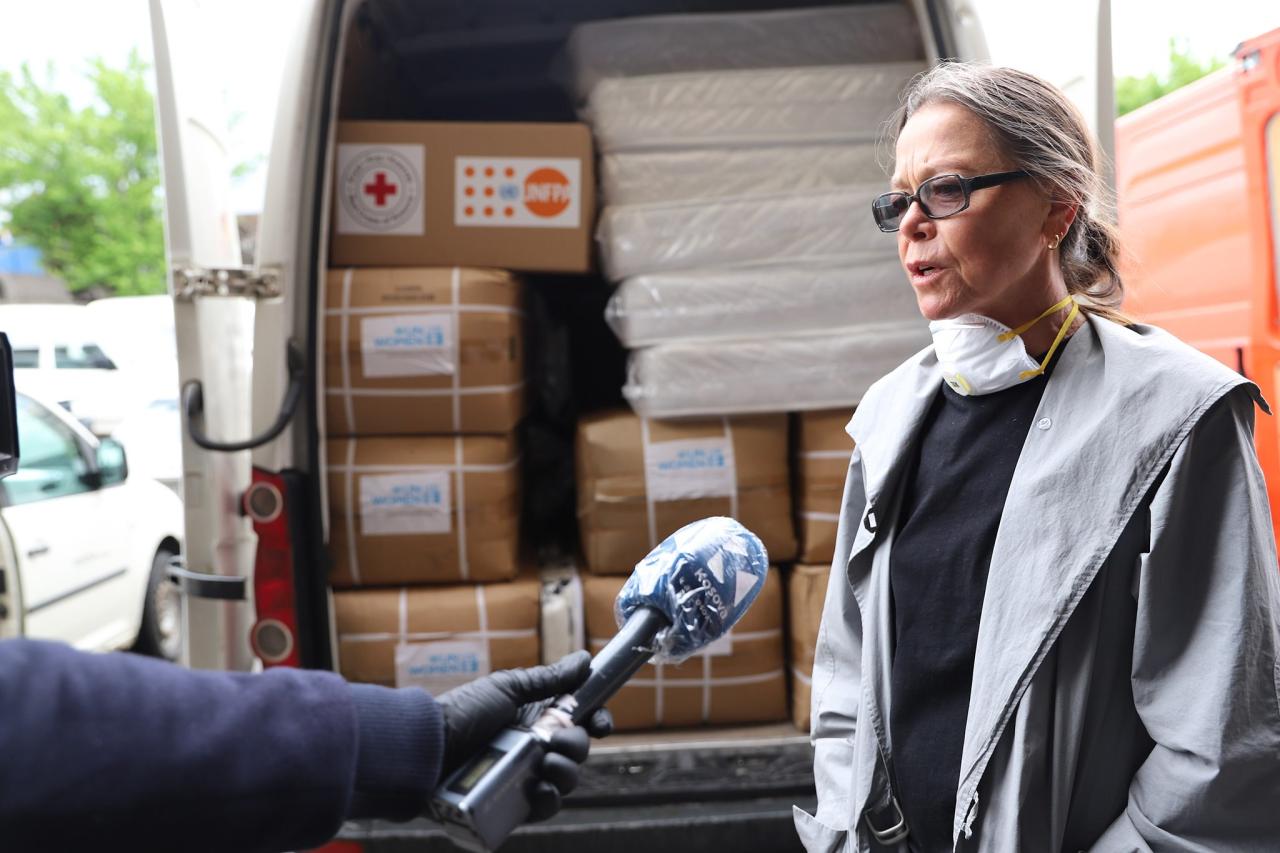 Kosovo's Development Coordinator, Ulrika Richardson answers a journalists question during the hand-over process of essential items.