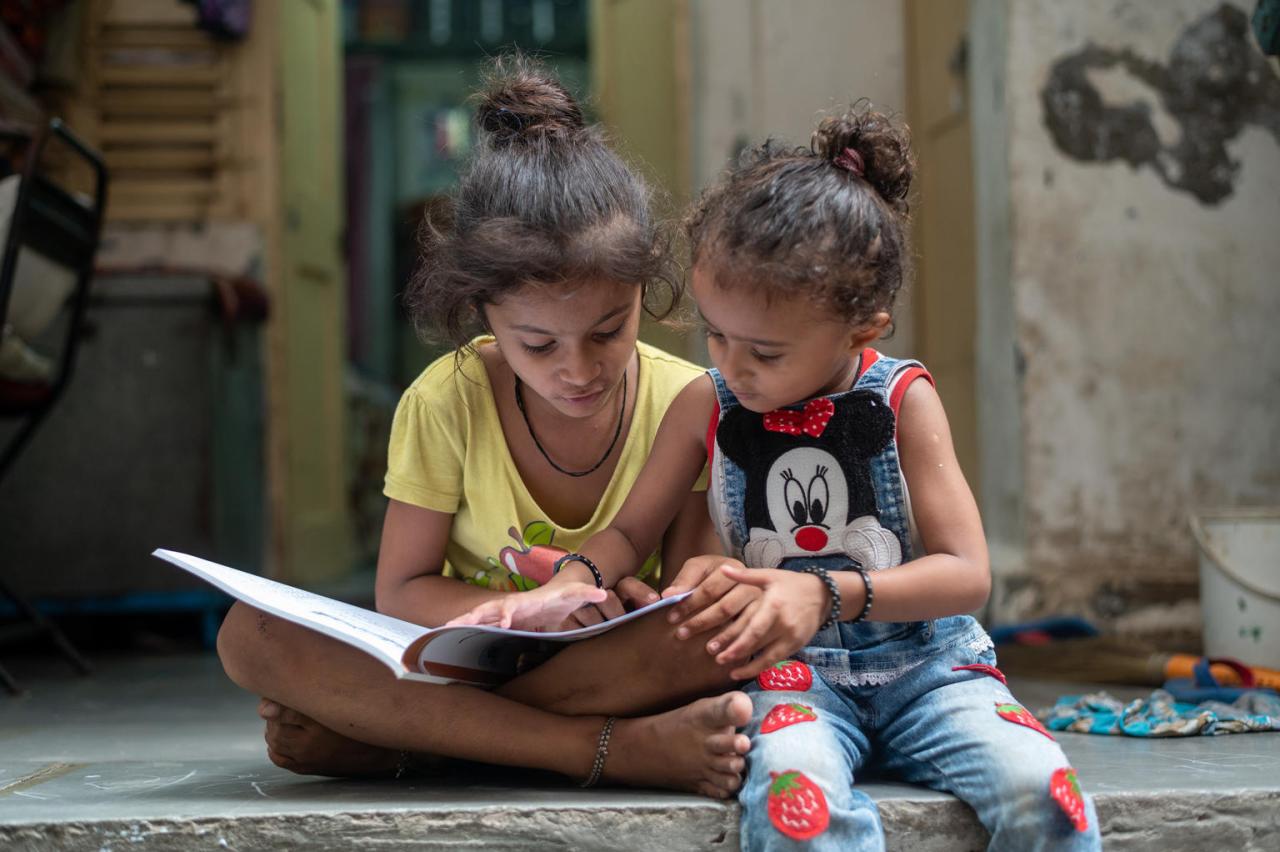 A young girl and her sister studying at home during COVID-19 lockdown.