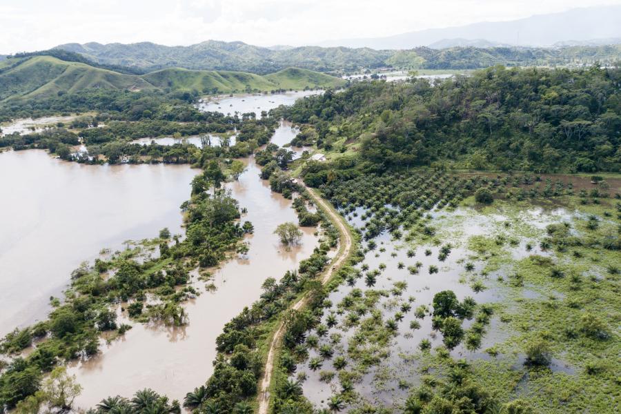 Aerial view of flooded waters and green land.
