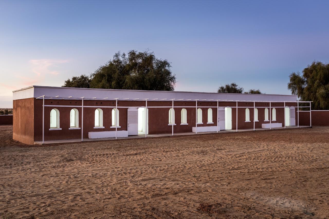 A building with lights on at dusk. 