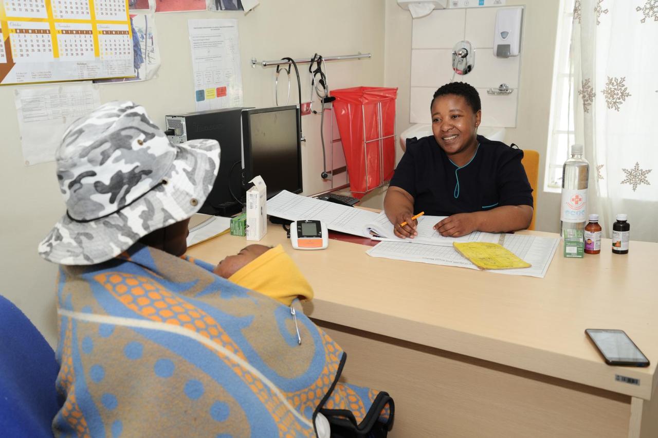 A woman is seated in front of a doctor