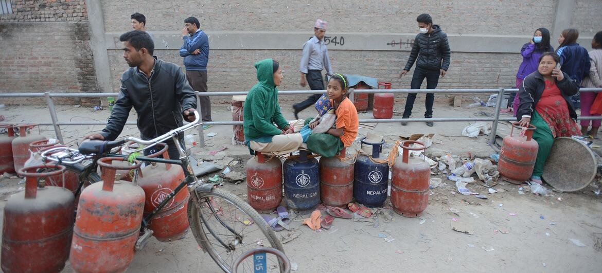 People wait in line with empty cooking gas cylinders in Kathmandu, Nepal. 