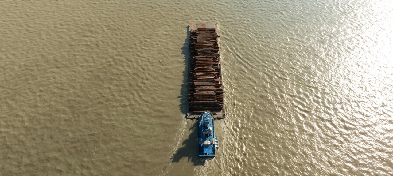 A logging ship navigates along the Amazon River.