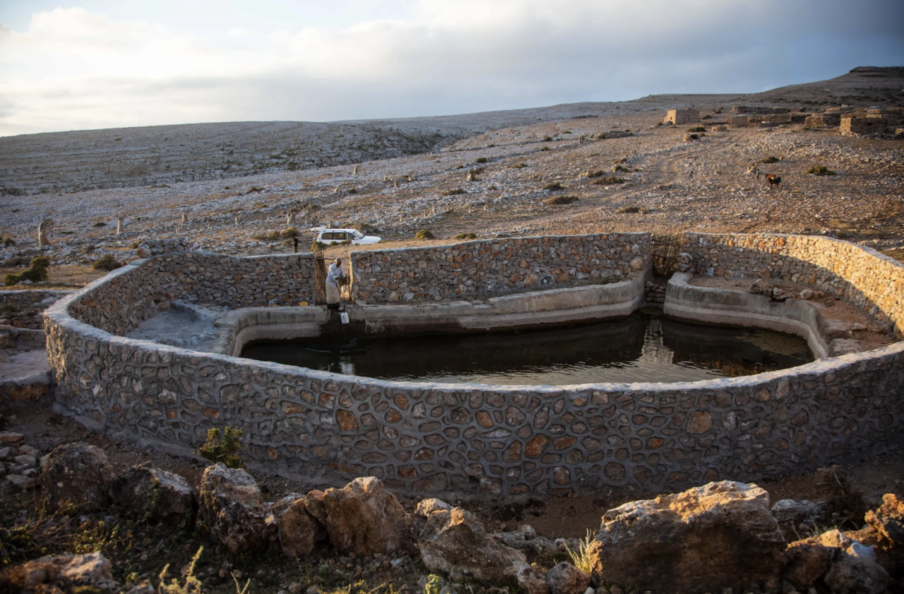 A wall around a rainwater reservoir.