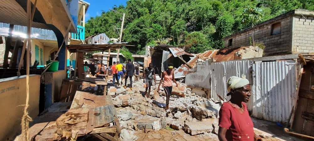 An image of the post earthquake destruction caused in Haiti with debris from homes on the street. 